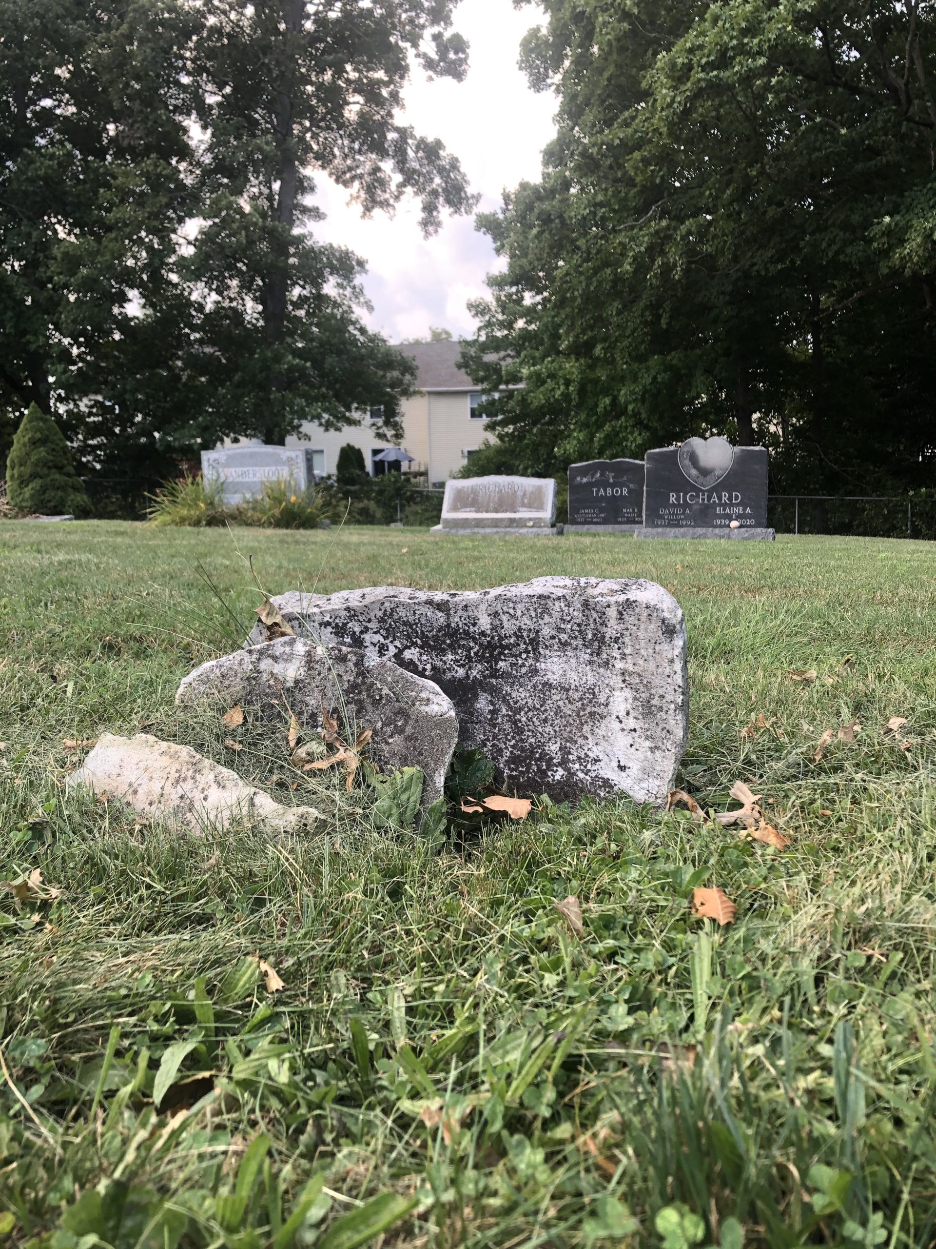 Pieces of Henry P. Freeman's headstone lay against the base. The stone is now too broken to repair.